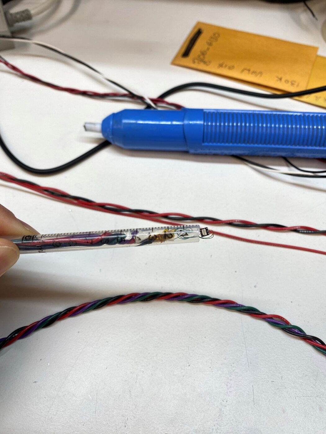 Hand-wired strain gauge sensor being tested on the bench